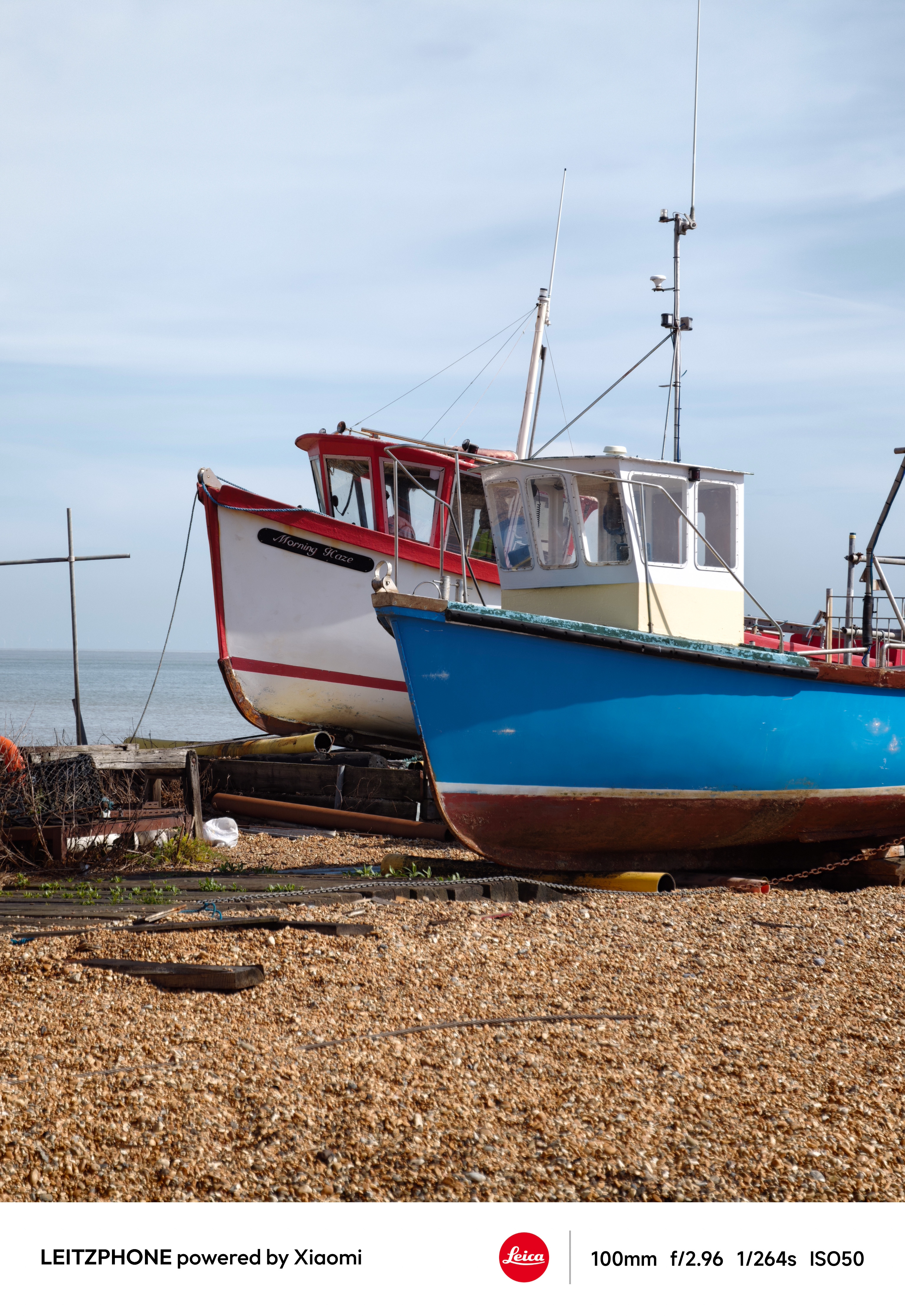 Two fishing boats resting on a pebbled beach