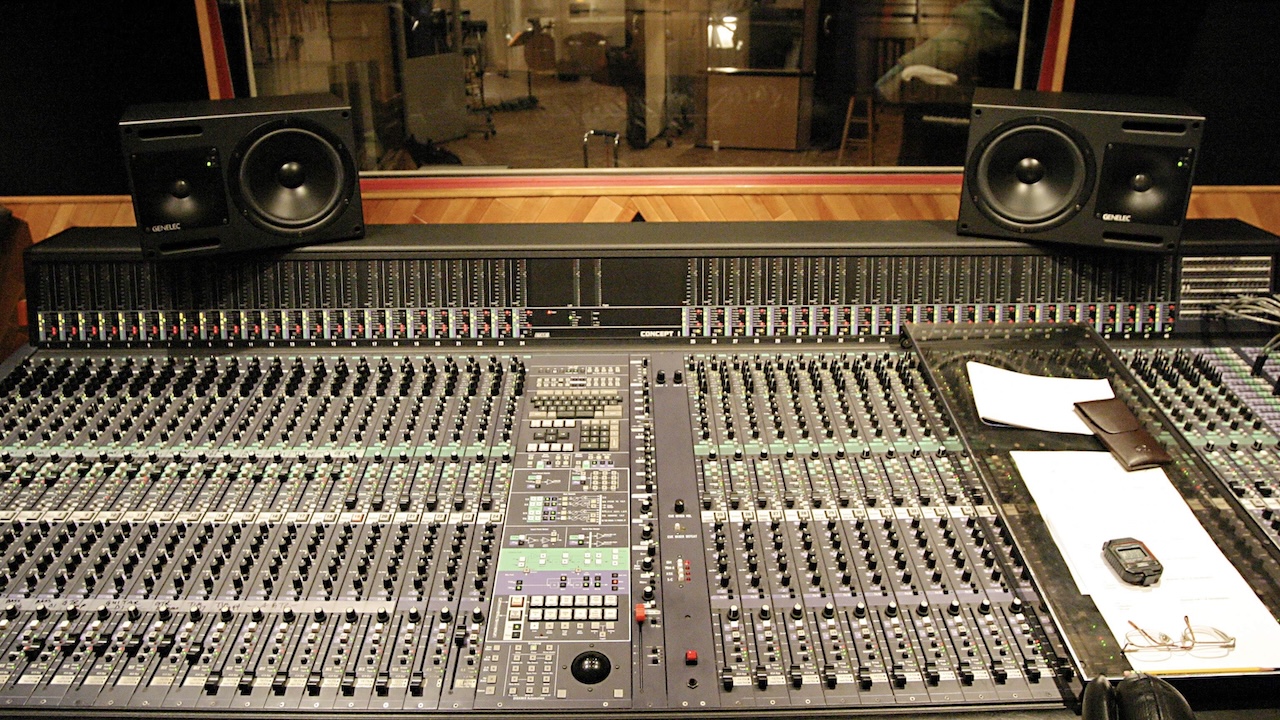 Monitor speakers and mixing desk in recording studio control room