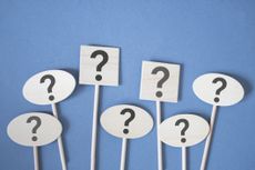 question marks on wooden sticks