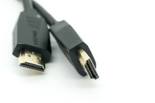 A close up of a pair of black and gold HDMI cables