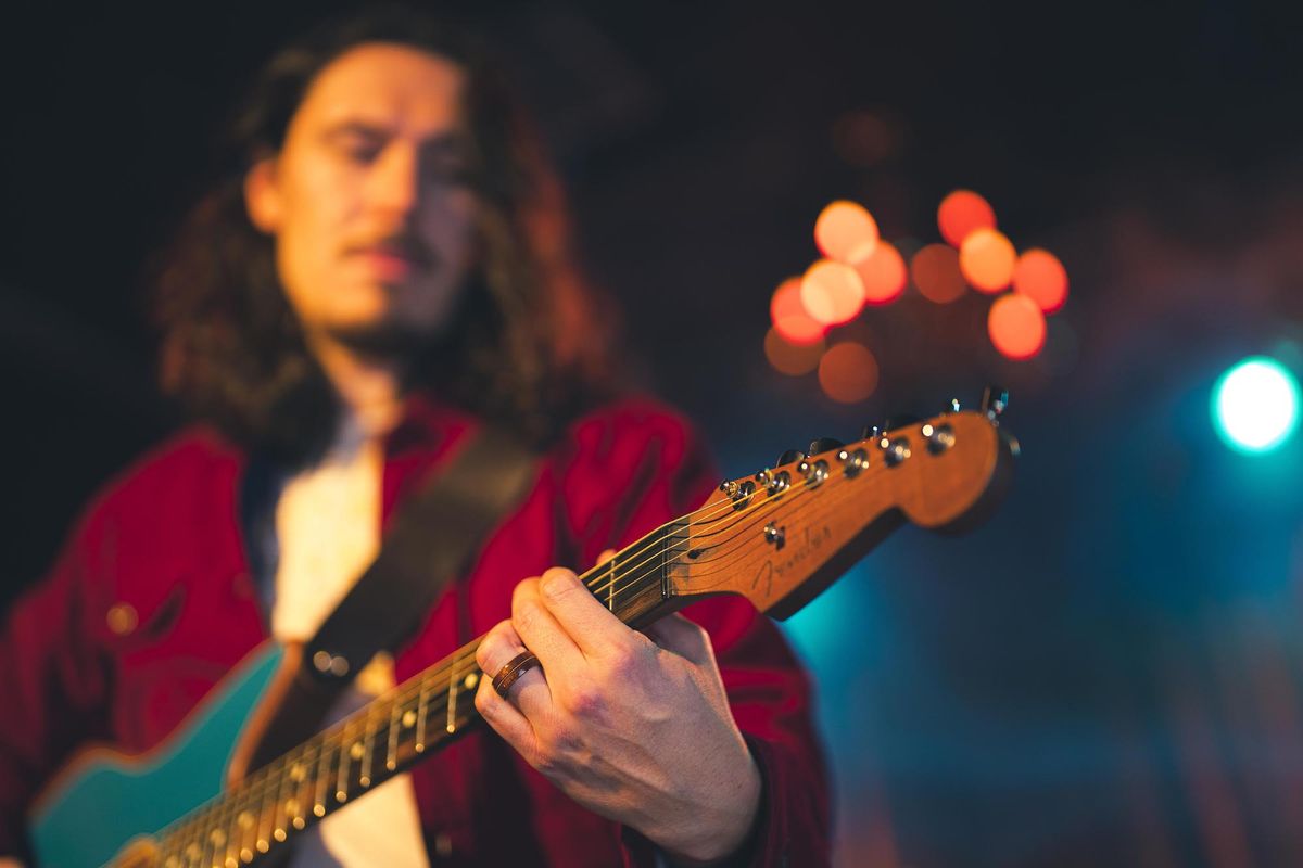 A guitarist wears one of Fender's new wedding rings on his left hand