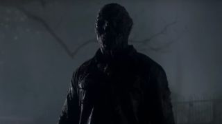 A zombie Jason Voorhees stands obscured by darkness in Friday The 13th, Part VI - Jason Lives.