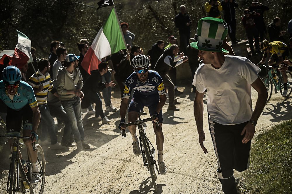 Julain Alaphilippe is surrounded by fans at Strade Bianche