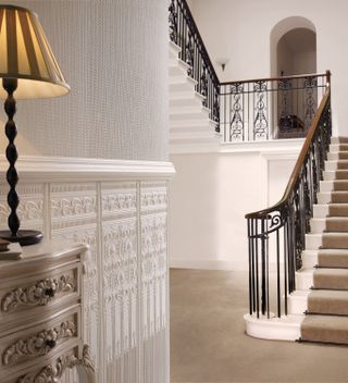 Textured white walls, metal stair rail