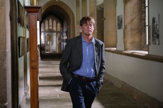 Beyond Paradise season 2 episode 4: DI Humphrey Goodman (Kris Marshall) walks down the whitewashed stone corridor of an elite boarding school with his hands in his pockets