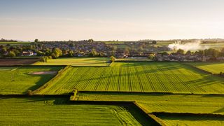 The village of Milbourne Port nestled amongst fields of crops and pasture in south Somerset, England