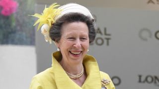 Princess Anne, Princess Royal smiles as jockey Joe Fanning (not pictured) poses with the trophy after riding Subjectivist to victory in the Gold Cup
