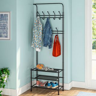 Blue wall wooden flooring with rack and clothes
