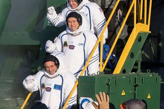 Cosmonaut Anton Shkaplerov of Roscosmos, and astronauts Norishige Kanai of JAXA and Scott Tingle of NASA are seen prior to boarding their Soyuz MS-07 spacecraft for the launch to the International Space Station on Dec. 17, 2017.