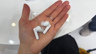 the earfun air pro 4+ earbuds in white showing the charging case, angled fit, and silicone ear tips