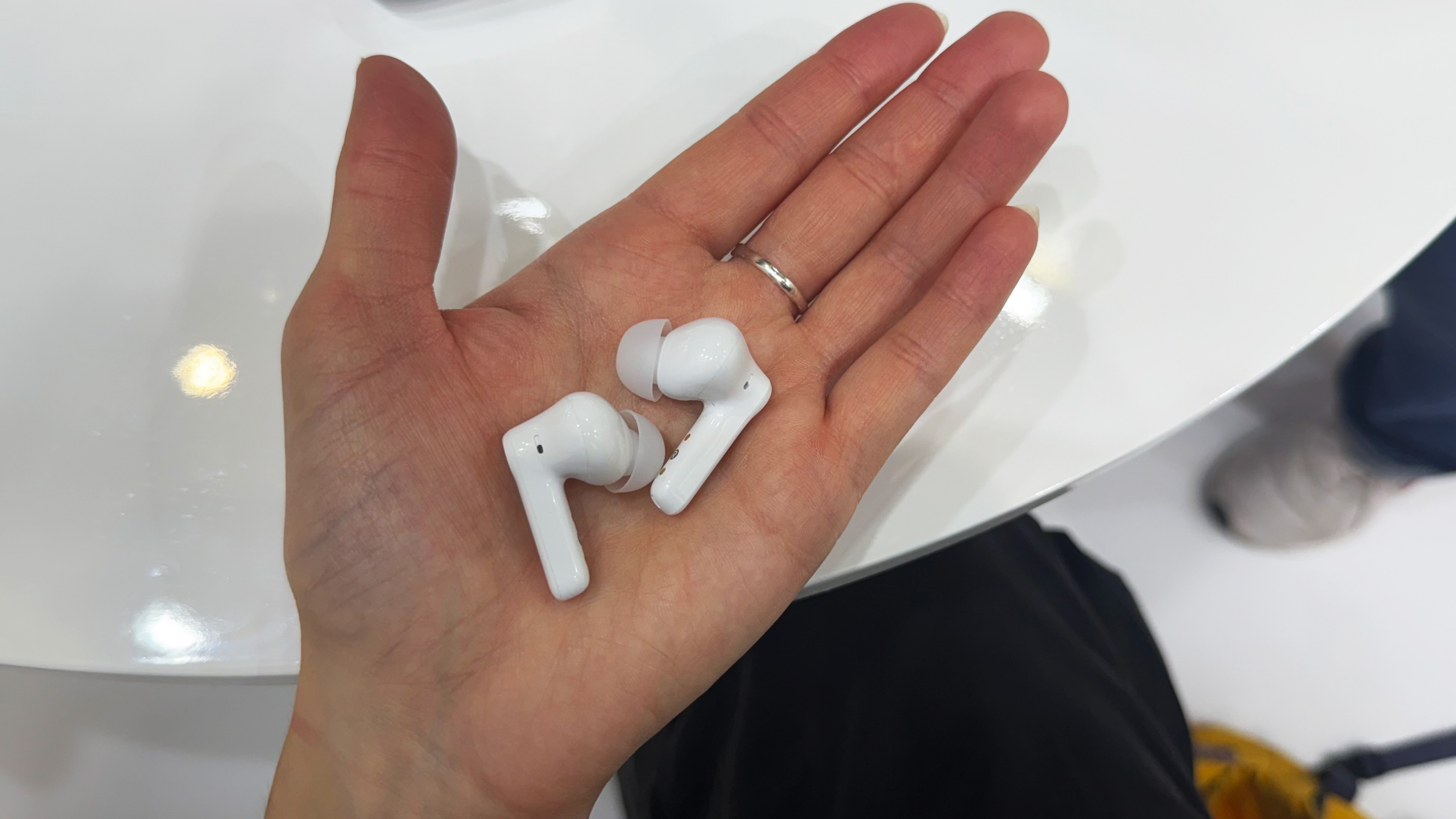 the earfun air pro 4+ earbuds in white showing the charging case, angled fit, and silicone ear tips