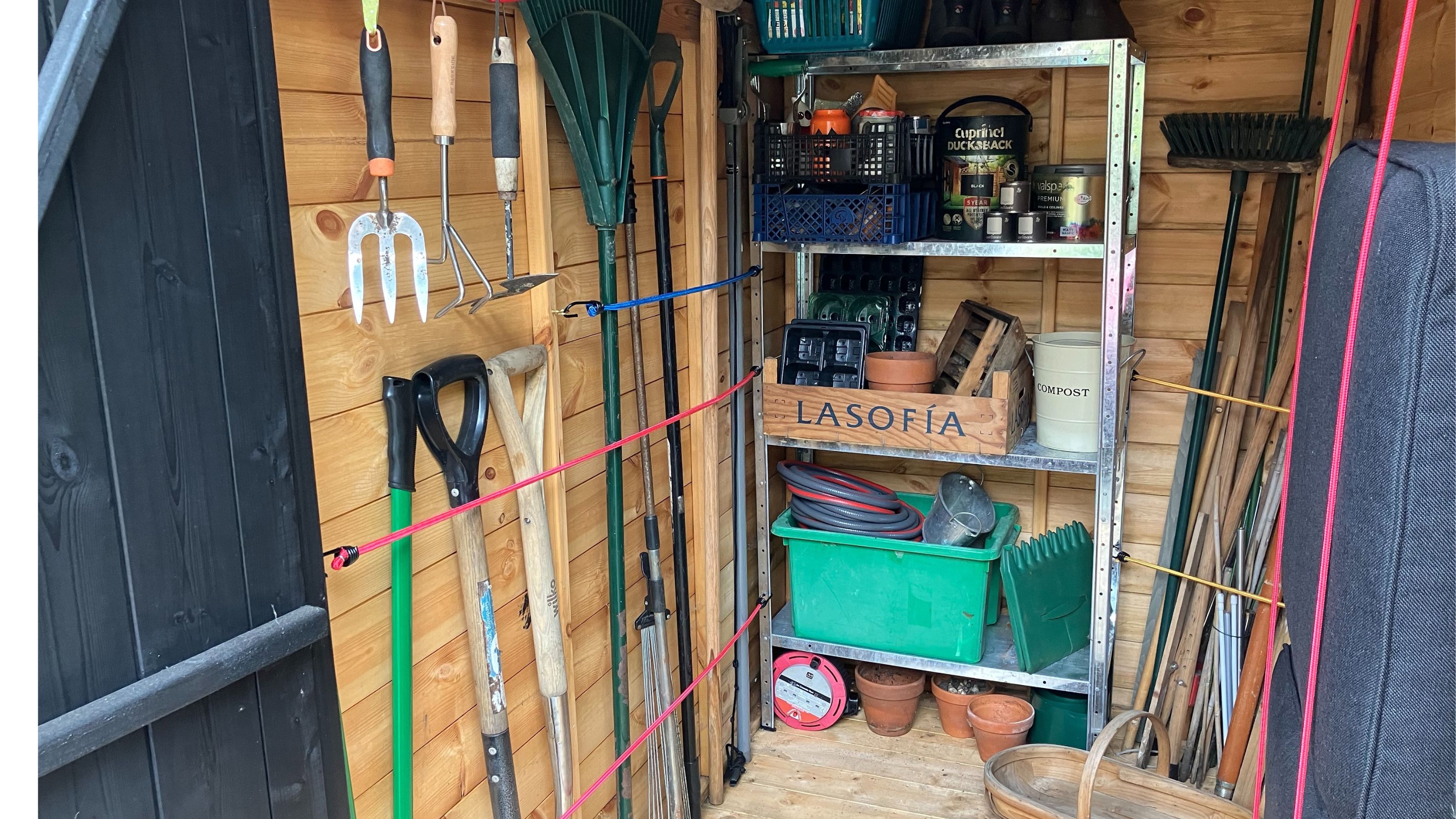 bungee cord shed storage with garden tools
