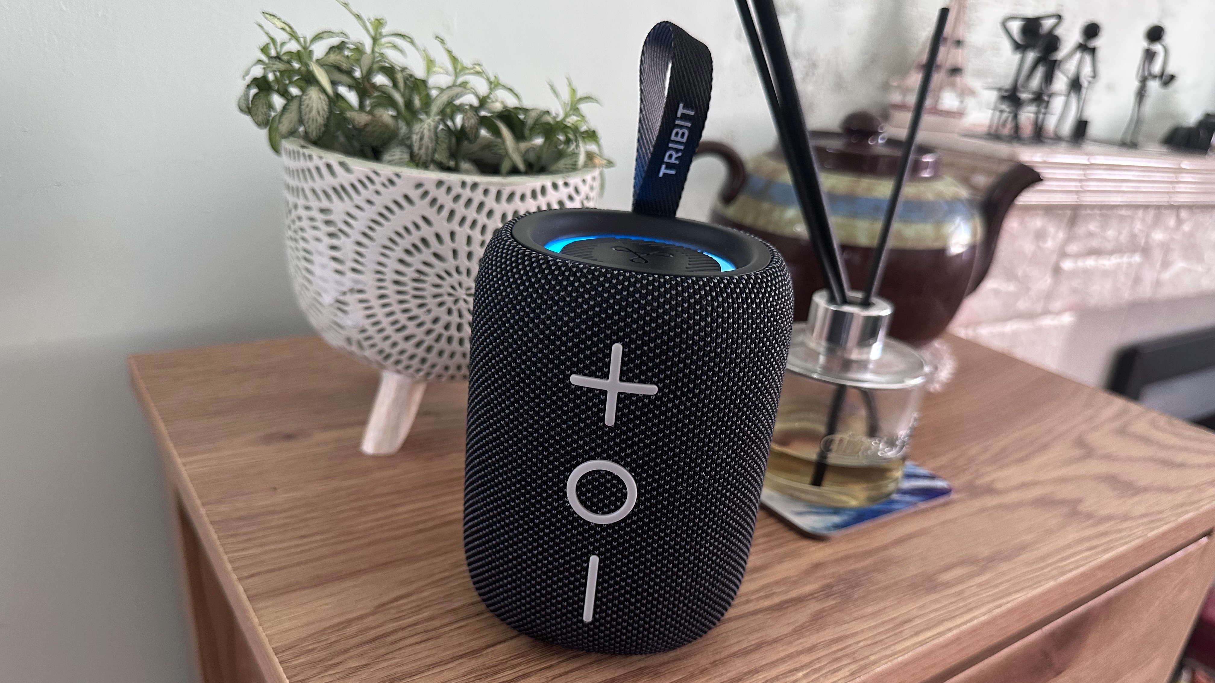 Tribit Stormbox Mini Plus Bluetooth speaker on a wooden surface