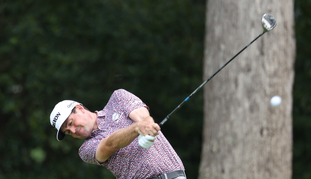 Keegan Bradley hits a fairway wood