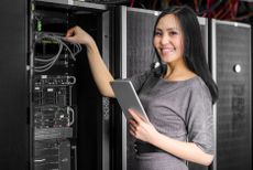 Asian woman working on tech hardware