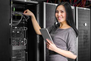 Asian woman working on tech hardware