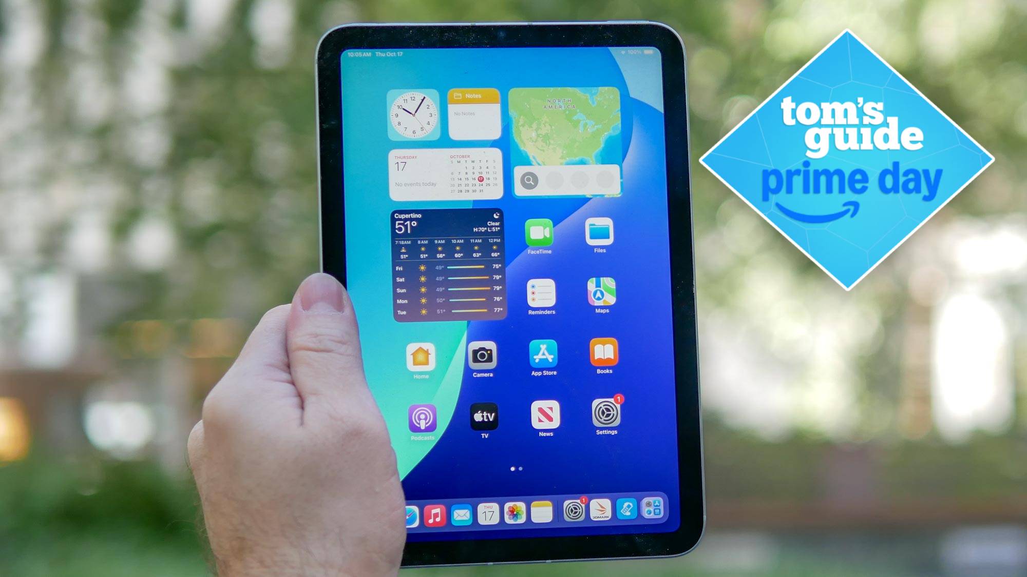 iPad mini 7 being held in hand with Tom's Guide Prime Day badge