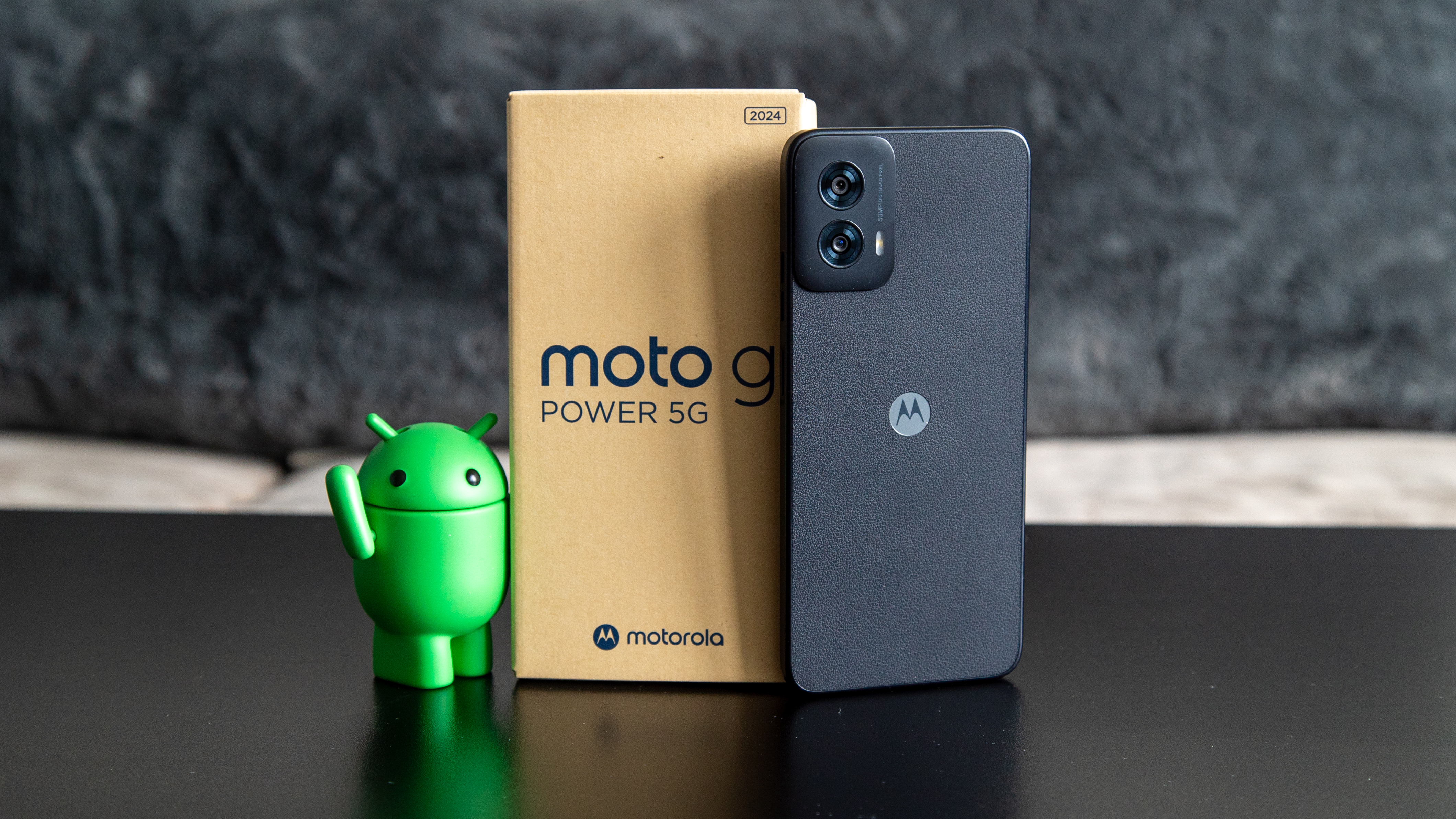 The Moto G Power 5G 2024 retail box with Google's "The Bot" figurine