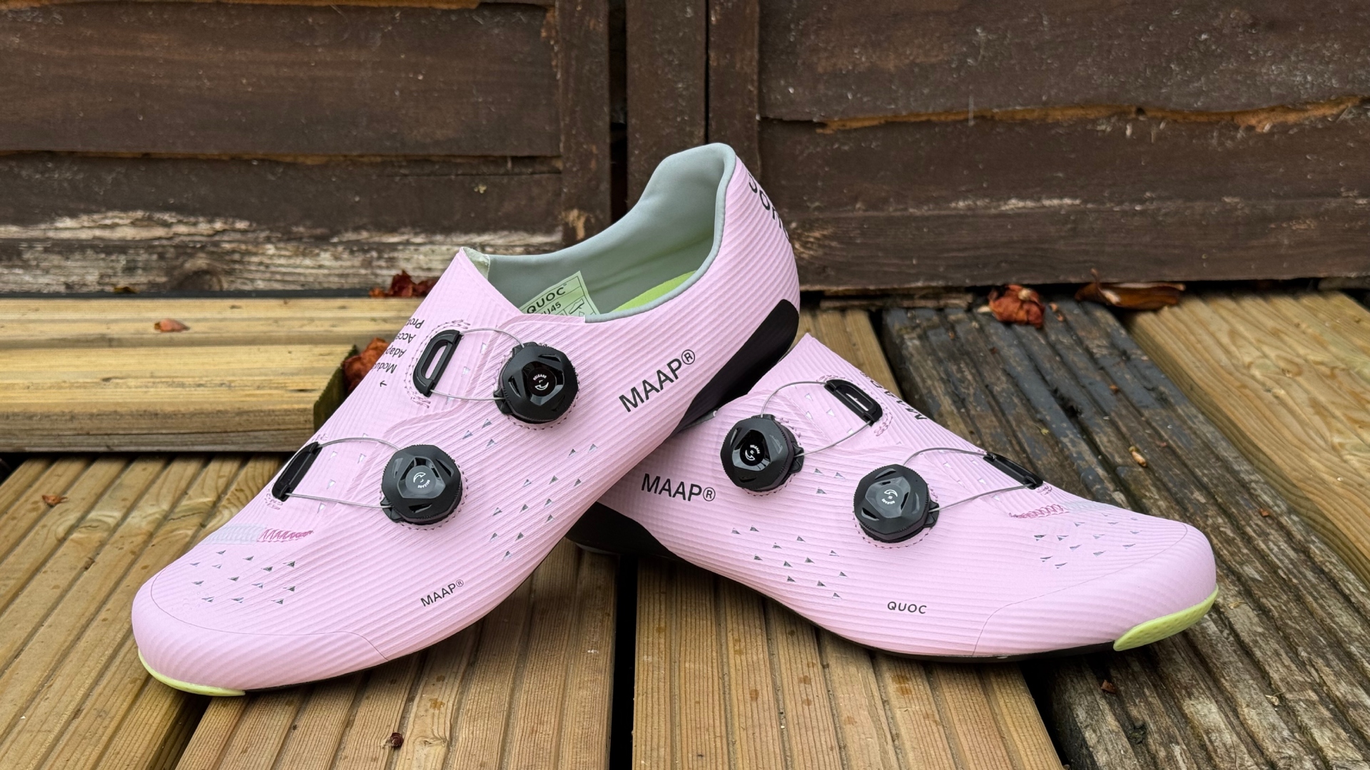 The MAAP x QUOC M3 shoes in pink on a wooden deck