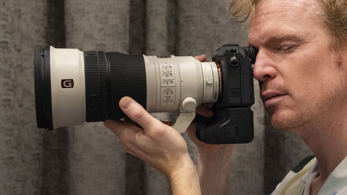 Sony FE 300mm F2.8 GM OSS lens in use with photographer looking through Sony A1 viewfinder