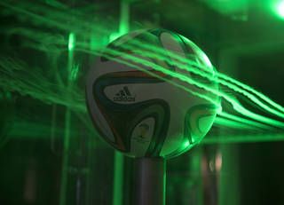 Smoke and lasers show the flow pattern around an Adidas Brazuca soccer ball at NASA's Ames Research Center.