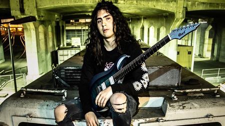 Hedras poses with his Cort signature guitar