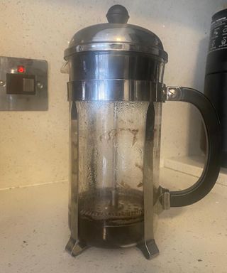 A used Bodum French press in white kitchen