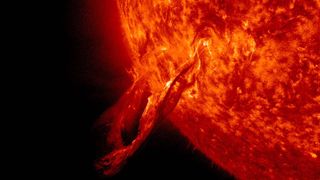 A solar flare that looks like a snake breaks away from the sun and into space