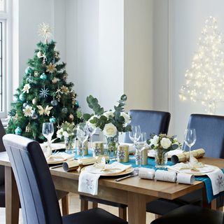 christmas table setting with teal table and christmas tree
