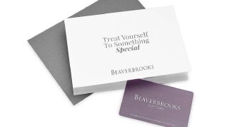 A Beaverbrooks gift card next to a white sign that says 'Treat Yourself To Something Special' on a white background.