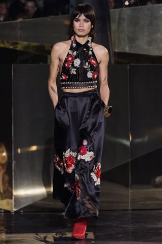 A model walks the runway in a Japanese inspired floral print outfit.