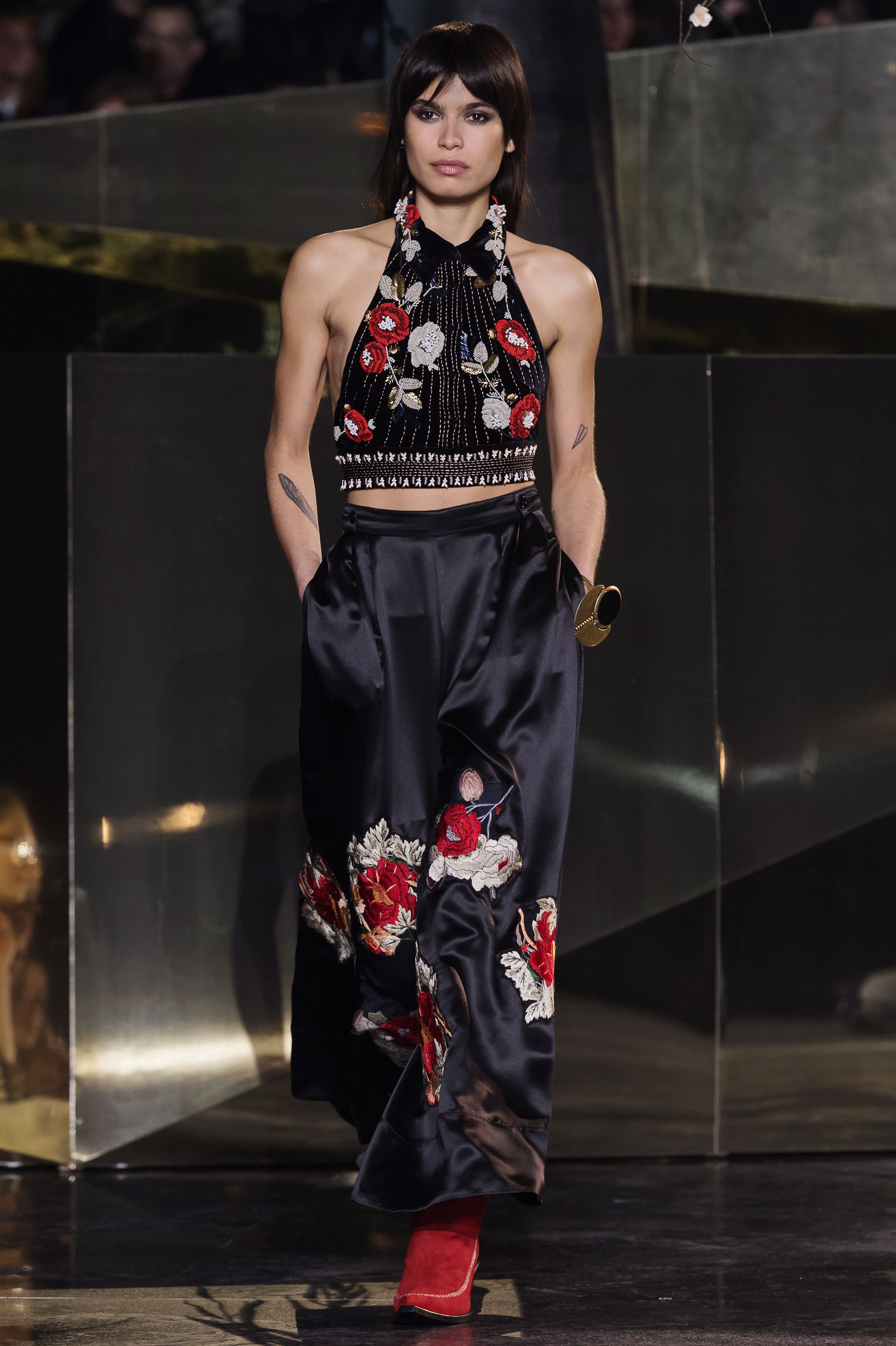 A model walks the runway in a Japanese inspired floral print outfit.