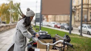 Woman looking through a secondhand sale with bike in the foreground