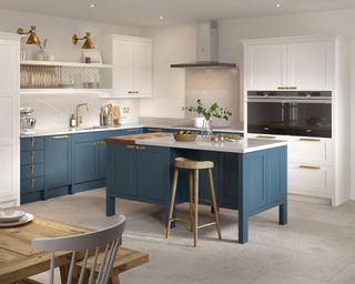 Two tone kitchen with dark blue cabinets and island, and contrast white cabinets and walls