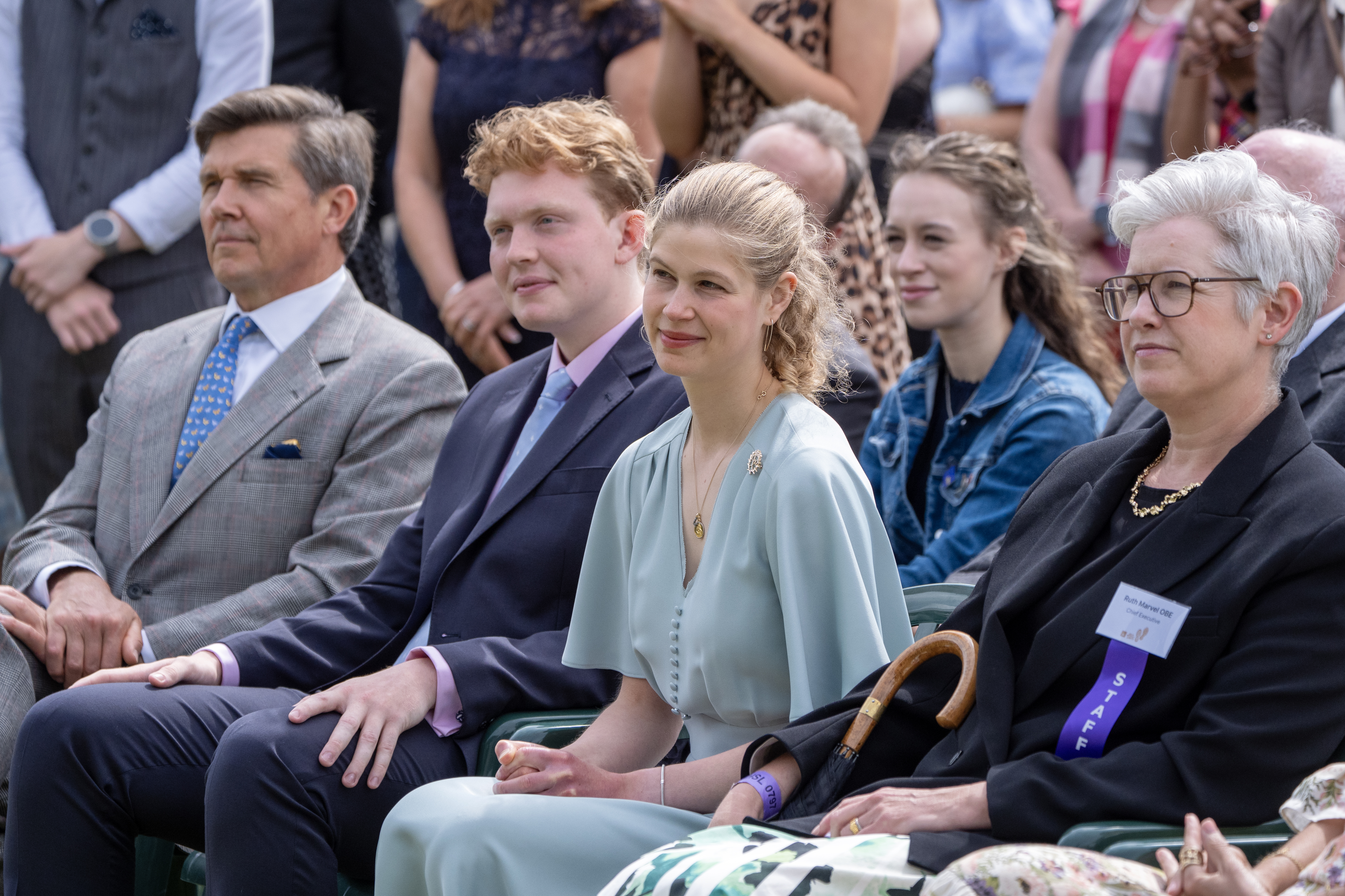 Lady Louise wearing a green dress sitting next to her boyfriend Felix da Silva-Clamp