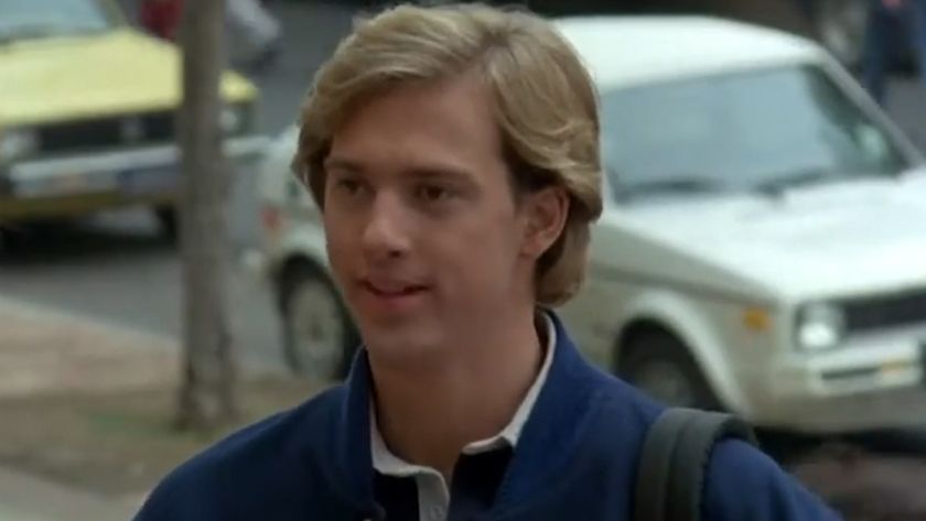 Anthony Edwards smiling in a blue jacket in Gotcha! 