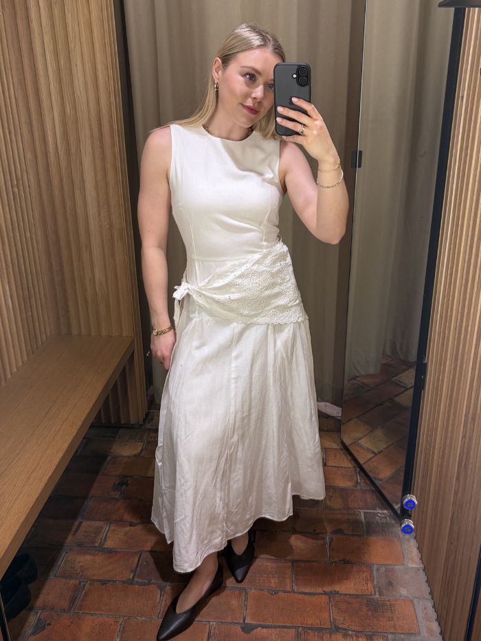 Woman wears white dress with handkerchief and brown ballet flats