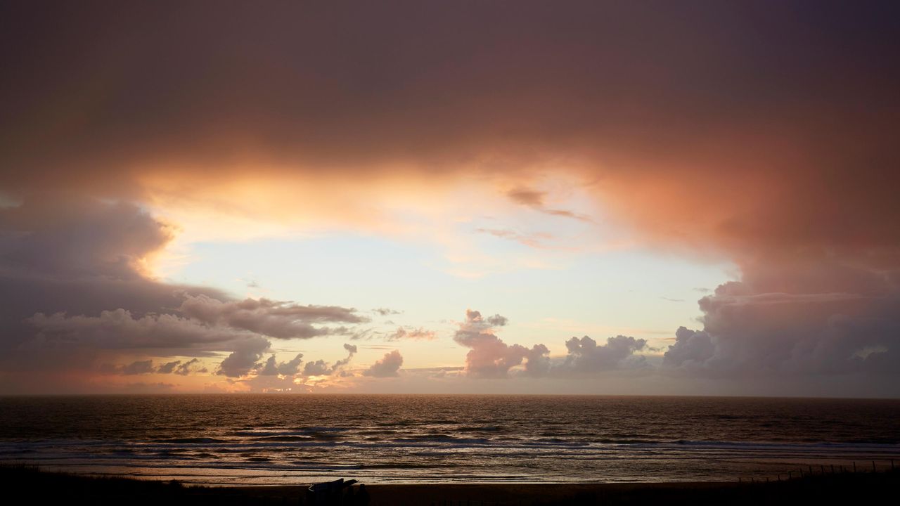 A hole in the clouds over the sea.