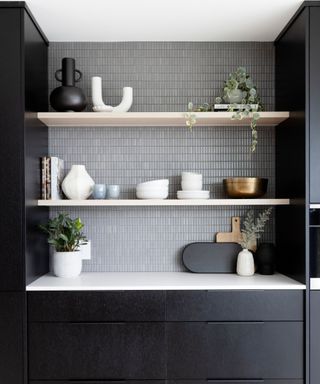 A kitchen with gray textured tile backsplash