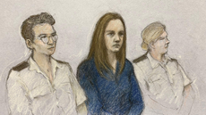 A court artist's drawing of Lucy Letby in Manchester Crown Court, sat beside two police officers