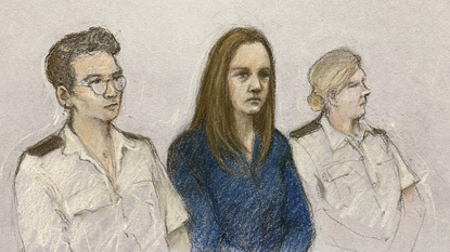 A court artist&#039;s drawing of Lucy Letby in Manchester Crown Court, sat beside two police officers