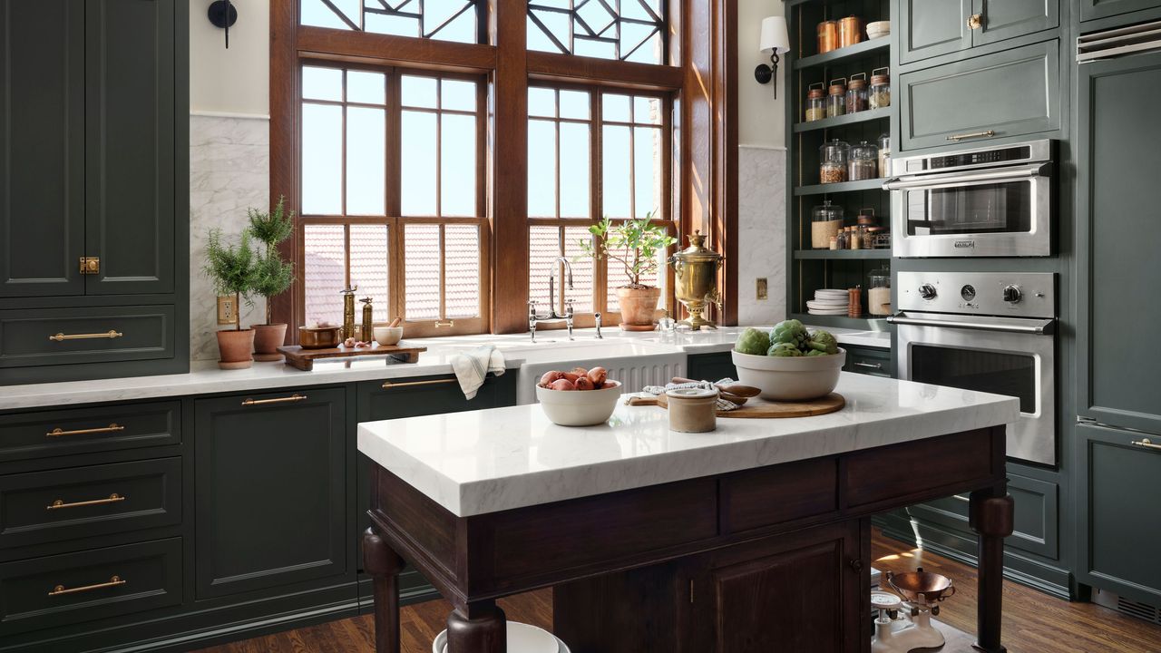 Joanna Gaines Castle kitchen with navy-green kitchen cabinet and marble countertops