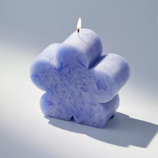 A sky blue daisy-shaped candle