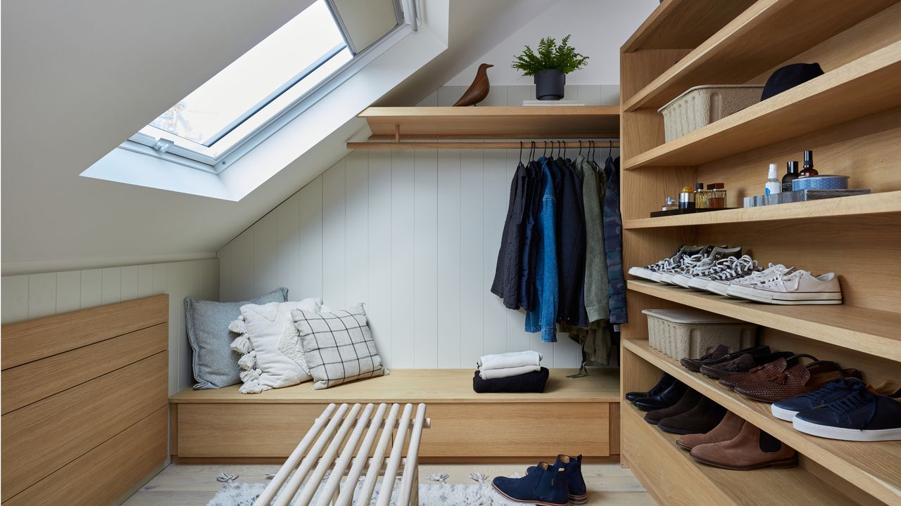 clothing storage with wooden shelving, containing shoes and jackets 