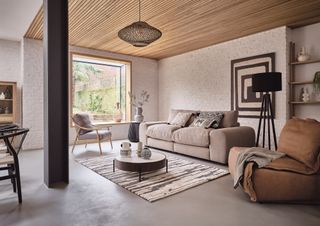 farmhouse living room with wooden ceiling and cream sofa