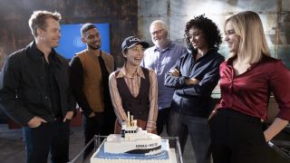 NCIS: Sydney main cast gathered around celebratory cake
