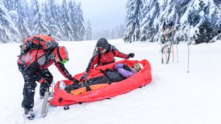 Ski patrol help an injured skier