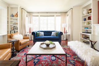 cape cod living room with shaggy sheepskin bench and oriental rug