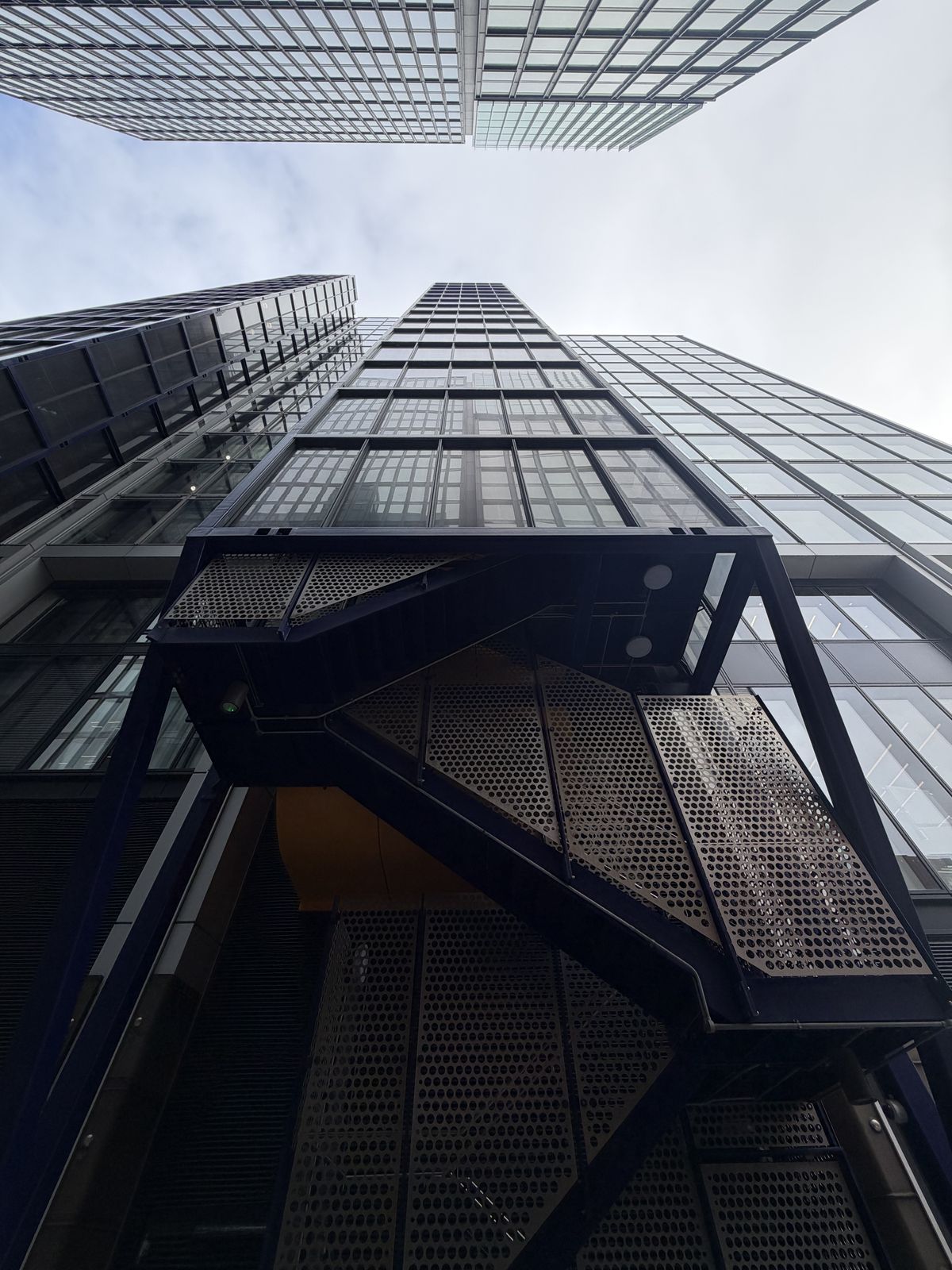 Sample photo from iPhone 17 Pro showing tall buildings shot from a low-down perspective
