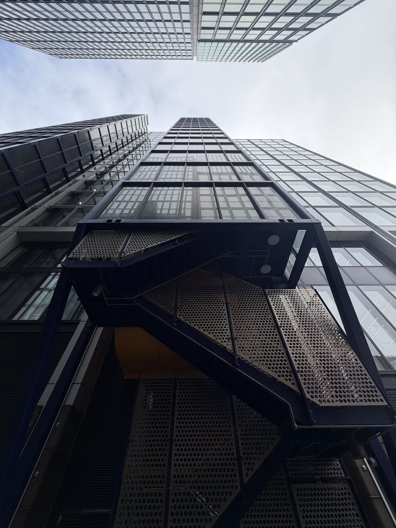 Sample photo from iPhone 17 Pro showing tall buildings shot from a low-down perspective